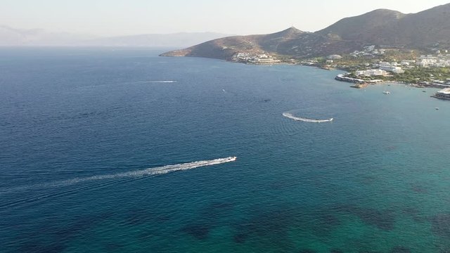Aerial view of a motor boat towing a water skier. Elounda, Crete, Greece