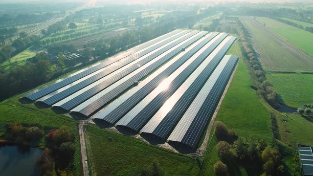 Solar Plant: Rows of Solar Panels Producing Sustainable Energy, Reflection From the Sun, Moving Left - Friesland, Netherlands / Holland &ndash; 4K Drone Footage