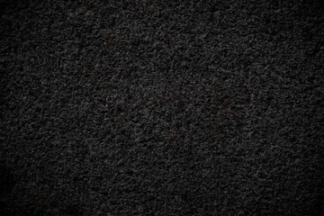 Black concrete rough porous texture dark background
