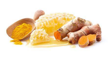 Honeycombs with turmeric root on white background