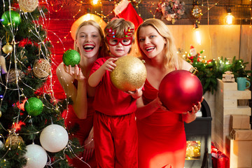 Happy Christmas family. Little boy in new year mask with two girls wearing red have fun. Christmas gifts. Gifts service. Helper of Santa with a Christmas magic gifts.