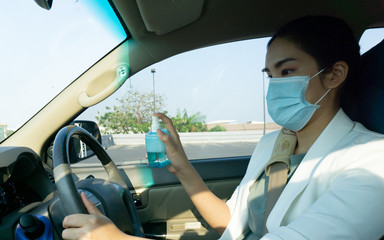 asian woman cleaning hand wheel in her car before going to work in the morning