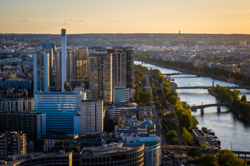 Aerial view of Seine and neighbourhoods of Paris from the Eiffel Tower at an afternoon in the sunset. 