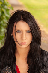 Naklejka premium Raven-haired girl in a lack leather jacket