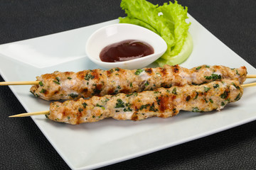 Minced pork skewer kebab with sauce