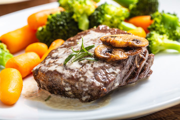 Juicy Beef Rib Eye Steak with mushroom sauce and baby vegetable