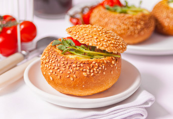 Egg served in bread bowl. Breakfast baked eggs in bread bowls with the fresh herbs.