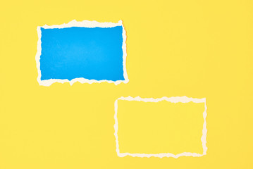 Two ripped paper torn edge sheets on a yellow background. Template with piece of color paper