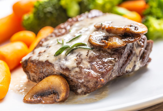 Juicy Beef Rib Eye Steak With Mushroom Sauce And Baby Vegetable