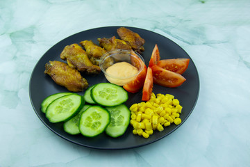 Stewed chicken wings with vegetables, corn and sauce