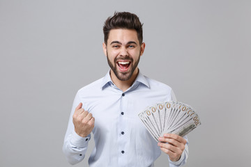 Happy unshaven business man in light shirt isolated on grey background. Achievement career wealth...