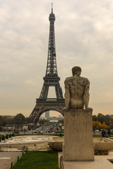 Fototapeta na wymiar Eiffel Tower and The Man - L'Homme statue in Jardins de Trocadero during sunset in autumn, Paris, France