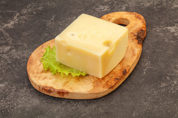 Emmental cheese over wooden board