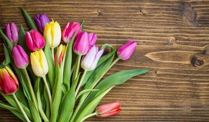 Spring tulips bouquet on wooden background with copy pace, spring greeting