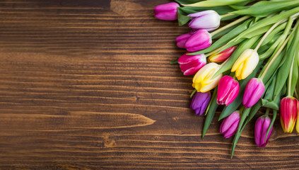 Spring tulips bouquet on wooden background with copy pace, spring greeting