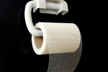 Concept of the economic crisis. Toilet paper in a grid on a black background. Joke.