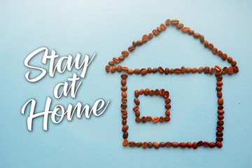 house from coffee beans  on a blue background staying at home with self quarantine to help slow outbreak and protect virus spread
