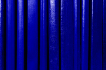 Dark blue book covers background. Books spines on shelf. Education and school concept.