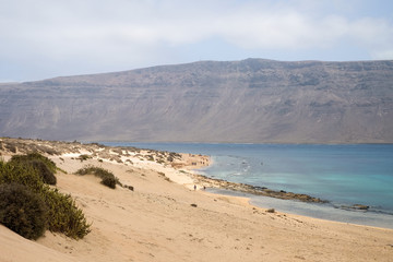 Paradise beach at La Graciosa Island with view on Lanzarote in the background, Canary Islands, Spain