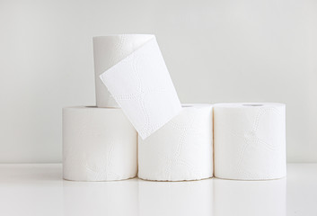 Rolls of toilet paper on light gray background
