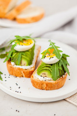 Toast with avocado, arugula and egg. Healthy Breakfast.