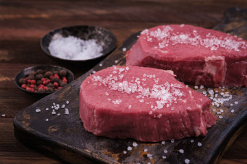Raw beef steak sprinkled with salt