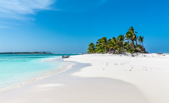 tiny little sandy island with palm tree and white sand beach in the turquoise lagoon of Cocos Keeling atollm landscapephotography