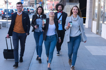 Fototapeta premium Portrait Of Business Team Outside Office. Meeting Concept. People Walking and drinking coffe, going to the office.
