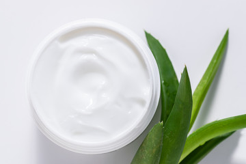 Obraz na płótnie Canvas Organic moisturizing cream with Aloe Vera extract for face care on white background top view. Natural cosmetic concept.
