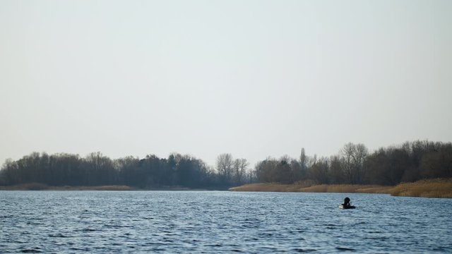 Boat with fishermen at the river at Sunset