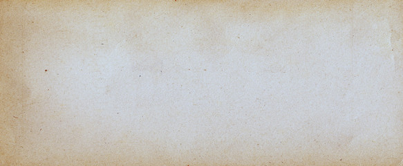 Old brown paper parchment background design with distressed vintage stains and ink spatter and white faded shabby center, elegant antique beige color