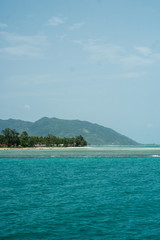 Photo of a tropical island surrounded by turquoise blue water near Kho Pagnang in Thailand