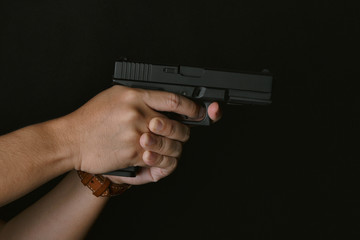 Man pointing gun ready to shoot, Killer with 9mm handgun pistol waiting for robbing the victim, Weapon and violence crime concept.