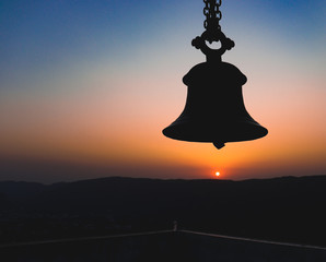 SUNRISE BEHIND A MOUNTAIN AND A BELL WHICH GIVES THIS PICTURE A HEAVENLY VIBE. DARK BUT RISING SHOWING THE RISE OF GOD FROM DARKNESS. BEST SUNRISE.