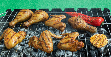 Grilled chicken legs wings on the barbecue griller. cooking process