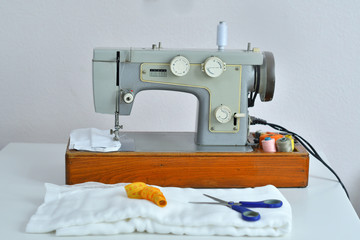 Homemade medical mask in the process. Sewing virus face mask at home. Detail on sewing machine.