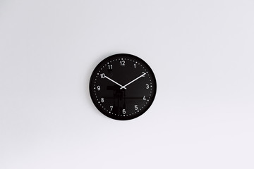 black clock on white wall