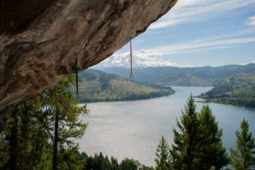 Climbing equipment on rock, lake in the forest