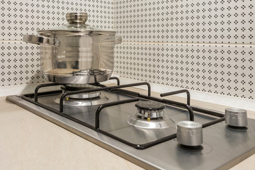 gas stove cooker on two burners with pan in the kitchen
