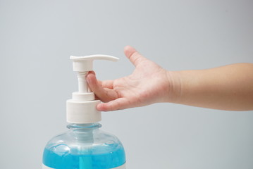Child hand picks soap or sanitizer for personal hygiene measures.