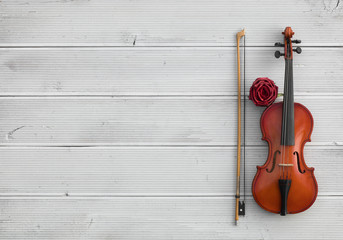 vintage violin on a white wooden background © serikbaib