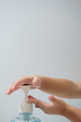 Child hand picks soap or sanitizer for personal hygiene measures.