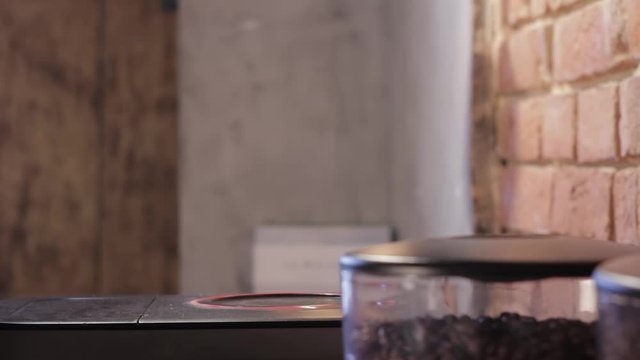 Male hand taking the kettle and then putting it back.