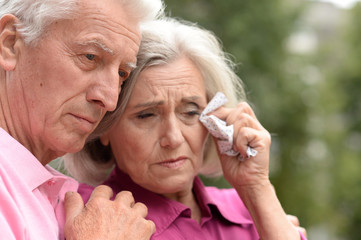 Close up portrait of unhappy senior couple