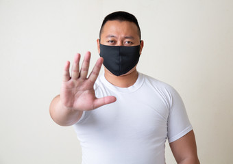 Asian Man in medical mask Coronavirus pandemic disease on grey background. COVID-19 virus from...