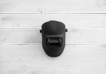 welding mask on a white wooden table