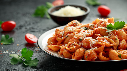 Conchiglie rigate pasta with chickpeas in tomato sauce with parmesan cheese. Healthy vegan food.