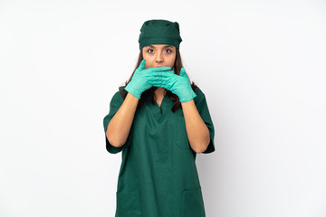 Surgeon woman in green uniform isolated on white background covering mouth with hands