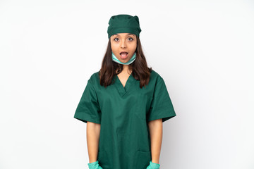 Surgeon woman in green uniform isolated on white background with surprise facial expression