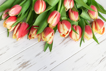beautiful red tulips on a white wooden background. spring flowers, bright bouquet, top view,flatlay